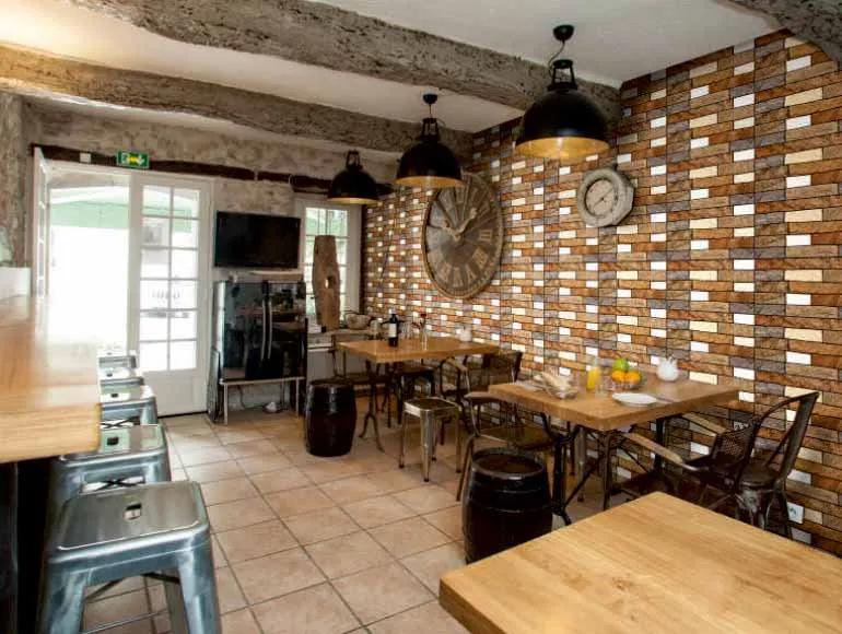 Rustic café with brick walls and industrial lighting in front elevation design.